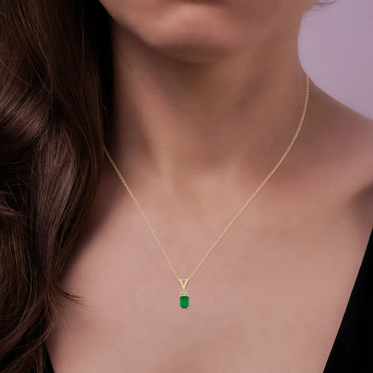 14K Yellow Gold 6X4Mm Emerald Shaped Emerald And Three Stone Diamond Pendant
