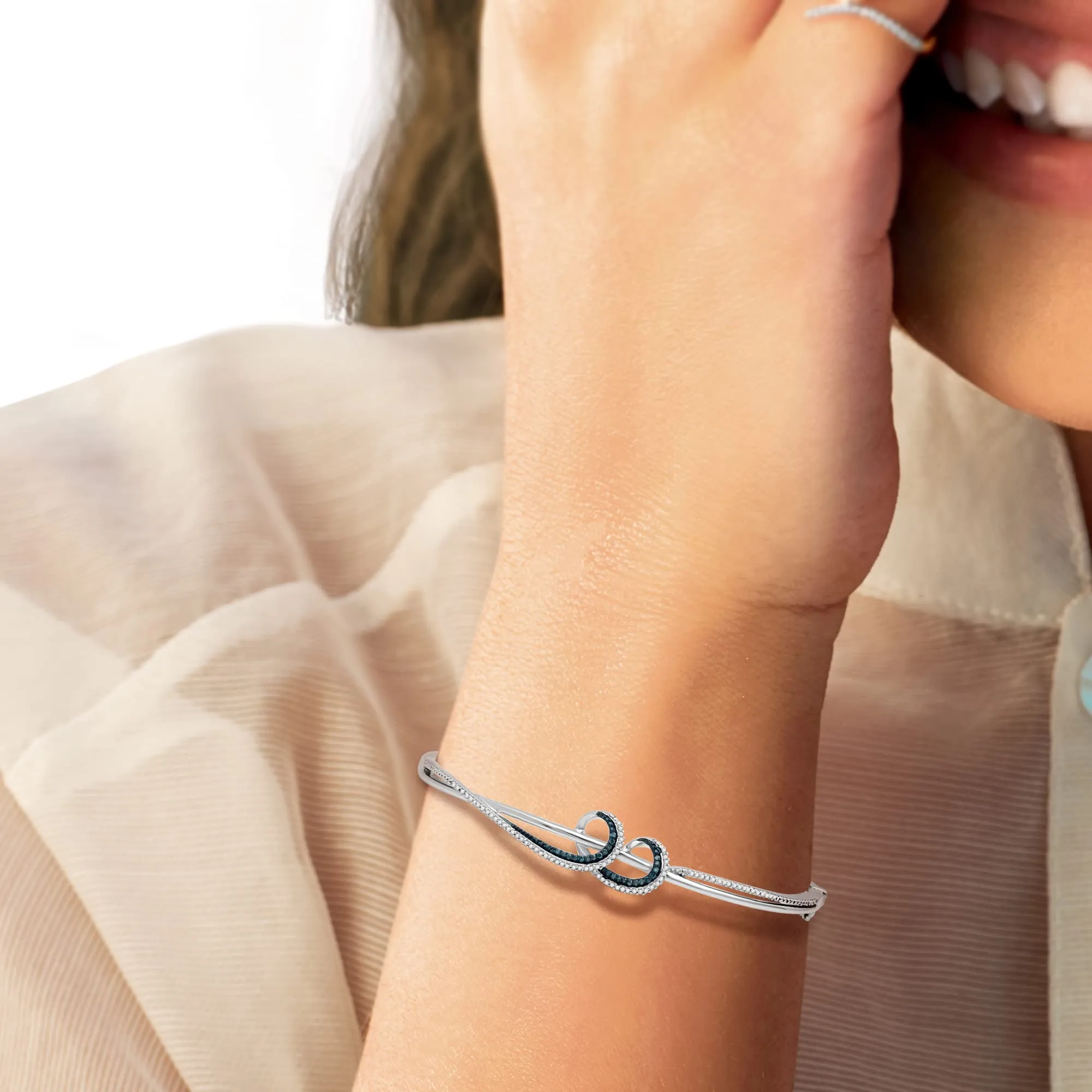Jewelili Sterling Silver With 1/3 CTTW Treated Blue Diamond and Natural White Round Diamond Wavy Bangle